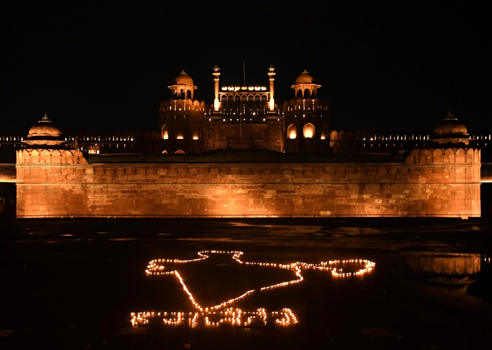 :NEW DELHI, INDIA - APRIL 18: Archaeological Survey of India (ASI) lights earthen lamps in the form of Indian map and illuminates the Red fort on the occasion of World Heritage Day and in solidarity with health workers during the nationwide lockdown, at a
