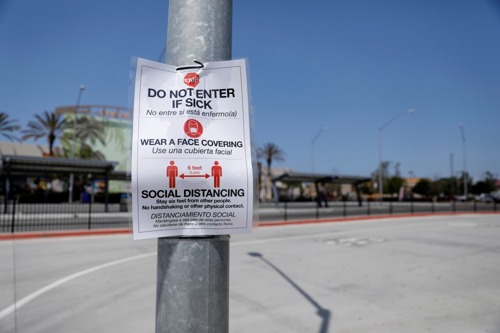 A coronavirus warning sign is posted at a closed pedestrian crossing at the U.S.-Mexico border during the coronavirus disease (COVID-19) outbreak in San Diego, California, U.S., April 21, 2020. REUTERS/Mike Blake
