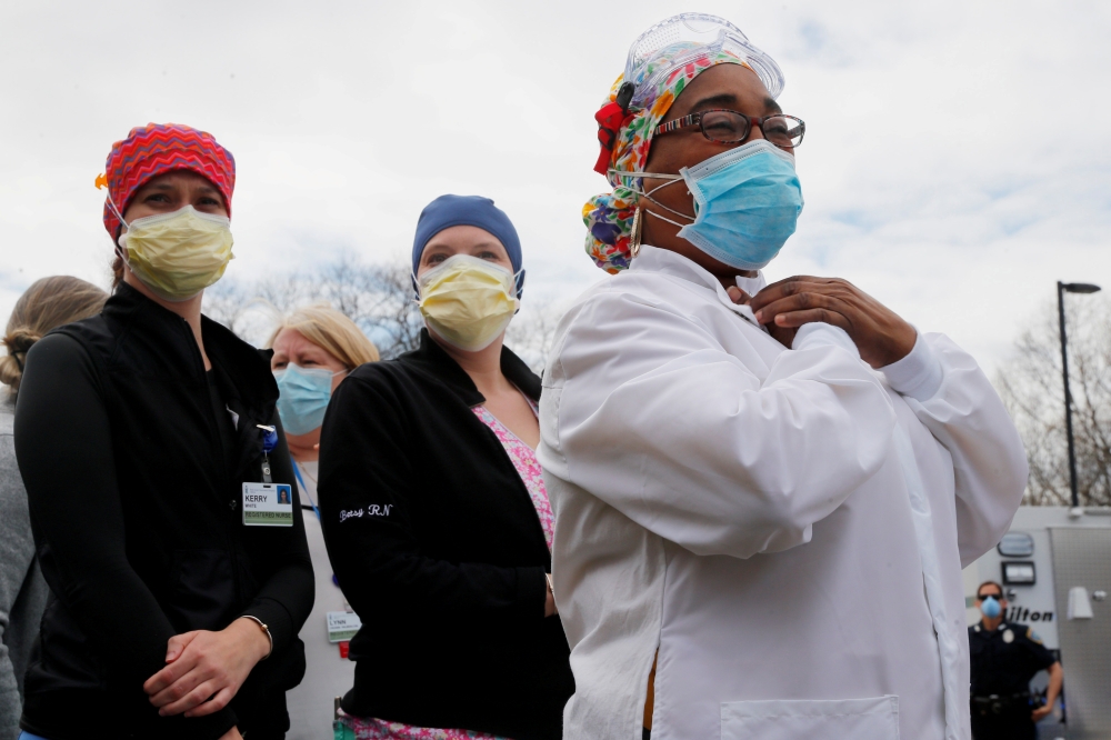 Healthcare workers react as police officers and firefighters thank them at Beth Israel Deaconess Hospital Milton amid the coronavirus disease (COVID-19) outbreak in Milton, Massachusetts, U.S., April 28, 2020. REUTERS/Brian Snyder 