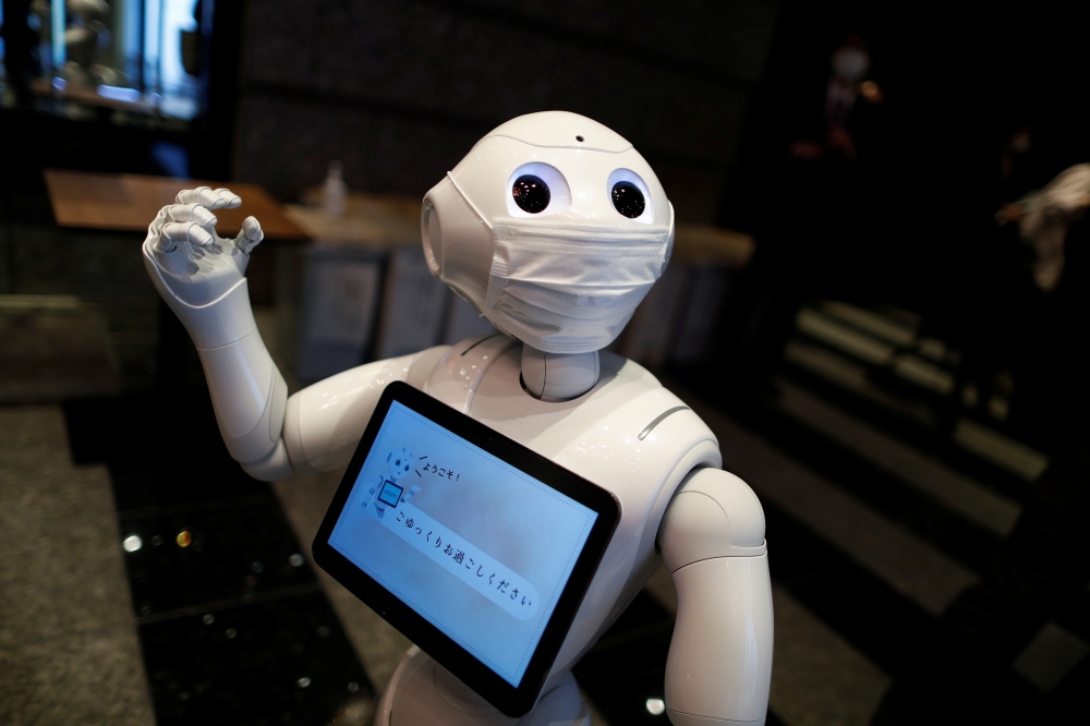 A Pepper humanoid robot, manufactured by SoftBank Group Corp. demonstrates how to check-in in a hotel of APA Group that has been designated to accommodate asymptomatic people and those with light symptoms of the coronavirus disease (COVID-19) to free up h