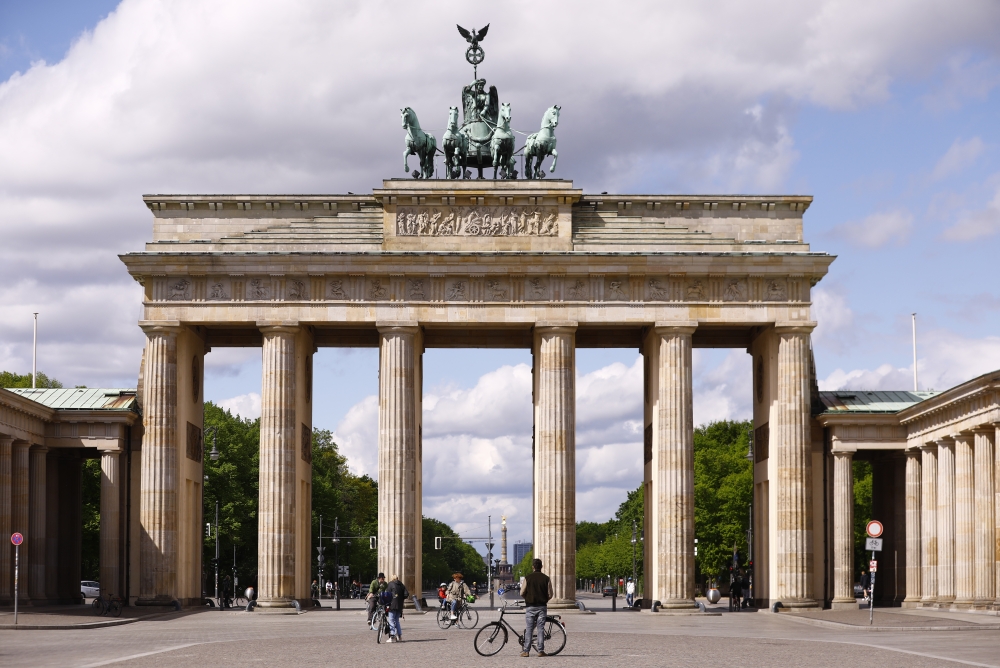 People ride bikes at nearly empty Brandenburg Gate and its surroundings in Berlin, Germany on May 01, 2020.  Abdulhamid Ho?ba? - Anadolu 