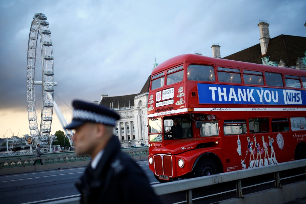 A bus displays a thank you message to the NHS on Westminster Bridge before the Clap for our Carers campaign in support of the NHS, following the outbreak of the coronavirus disease (COVID-19), in London, Britain, April 30, 2020. REUTERS/Henry Nicholls
