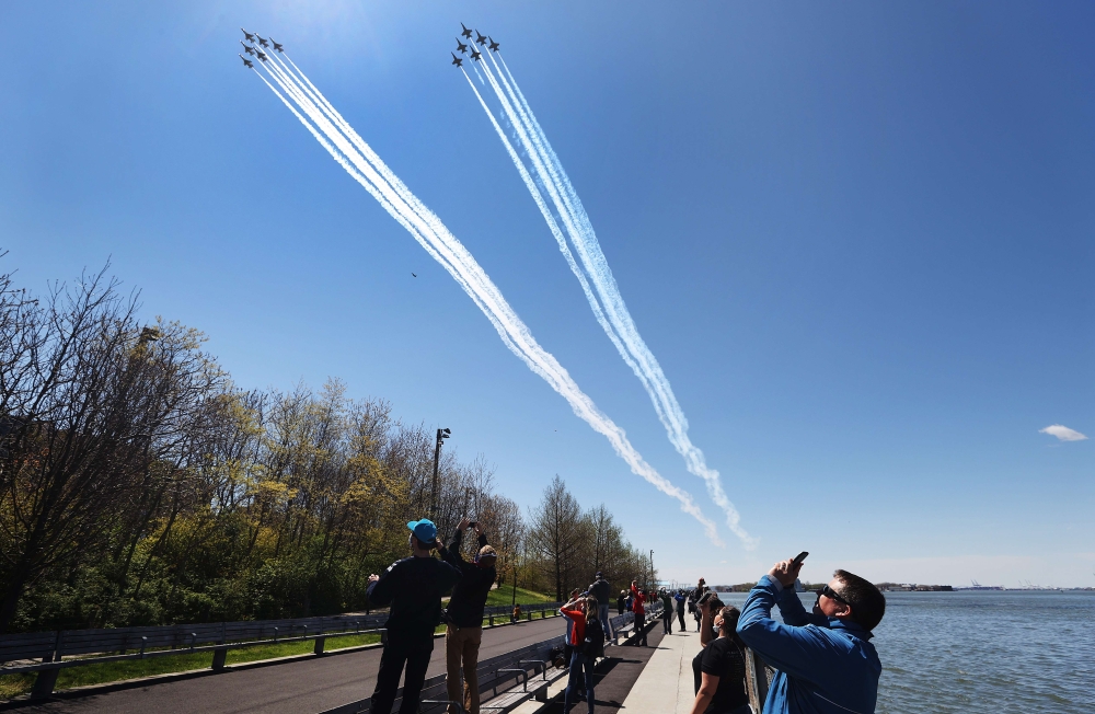 NEW YORK, - APRIL 28: The U.S. Navy's Blue Angels and U.S. Air Force's Thunderbirds perform a flyover across Brooklyn Bridge park as a tribute to honor NYC COVID-19 frontline workers on April 28, 2020 in the Brooklyn borough of New York City. The World He