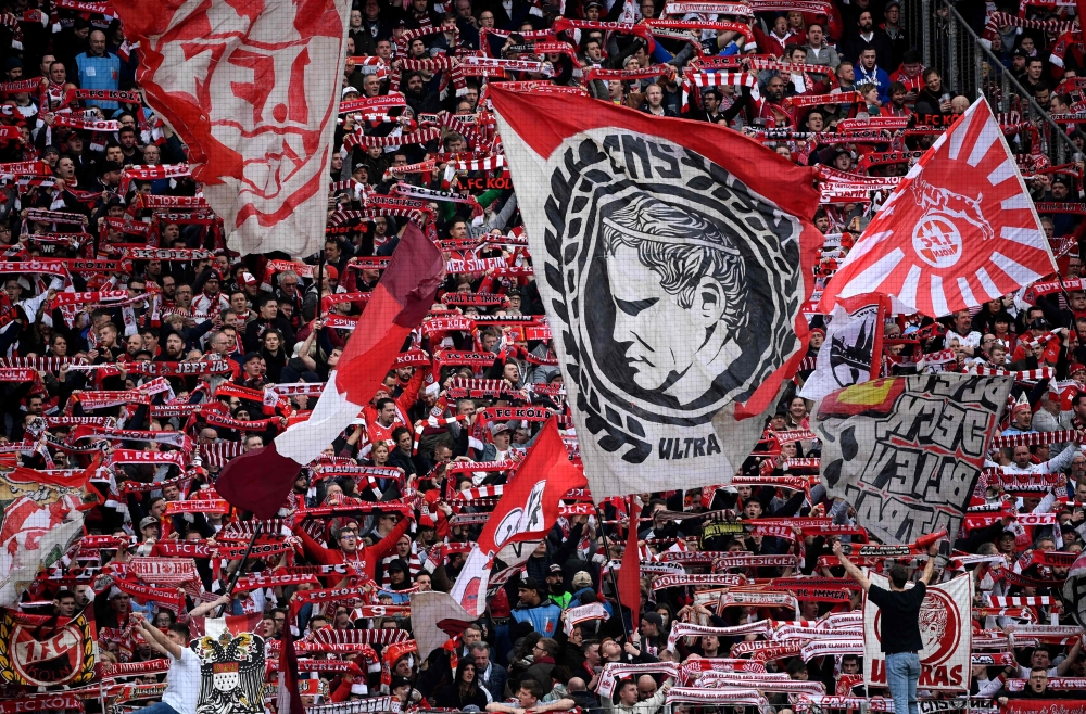 FILE PHOTO: Cologne's supporters wave their flags during the German first division Bundesliga football match 1 FC Cologne v FC Bayern Munich in Cologne, western Germany. / AFP / INA FASSBENDER
