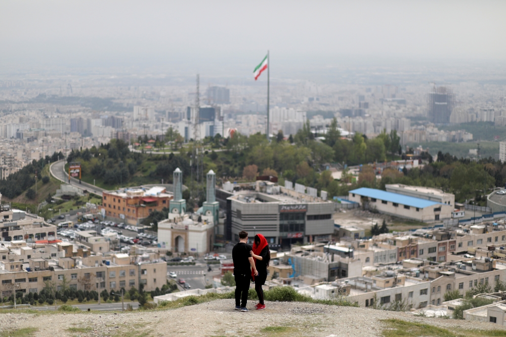 File photo: An Iranian couple is seen following the outbreak of the coronavirus disease (COVID-19), in Tehran, Iran, April 30, 2020. WANA (West Asia News Agency)/Ali Khara via REUTERS/File Photo