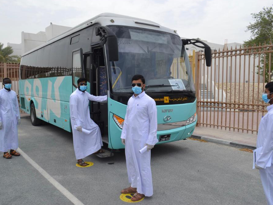 Students of the Religious Institute (Al Mahad Al Adini) boarding a school bus while following the social distancing guidelines to prevent the COVID-19 spread. 