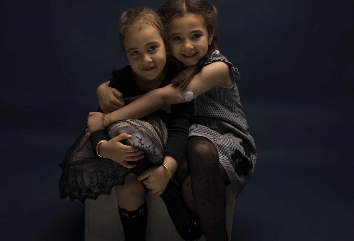 Alia, right, with her sister. She was one of the first cohort of young patients to use the hybrid closed-loop pump