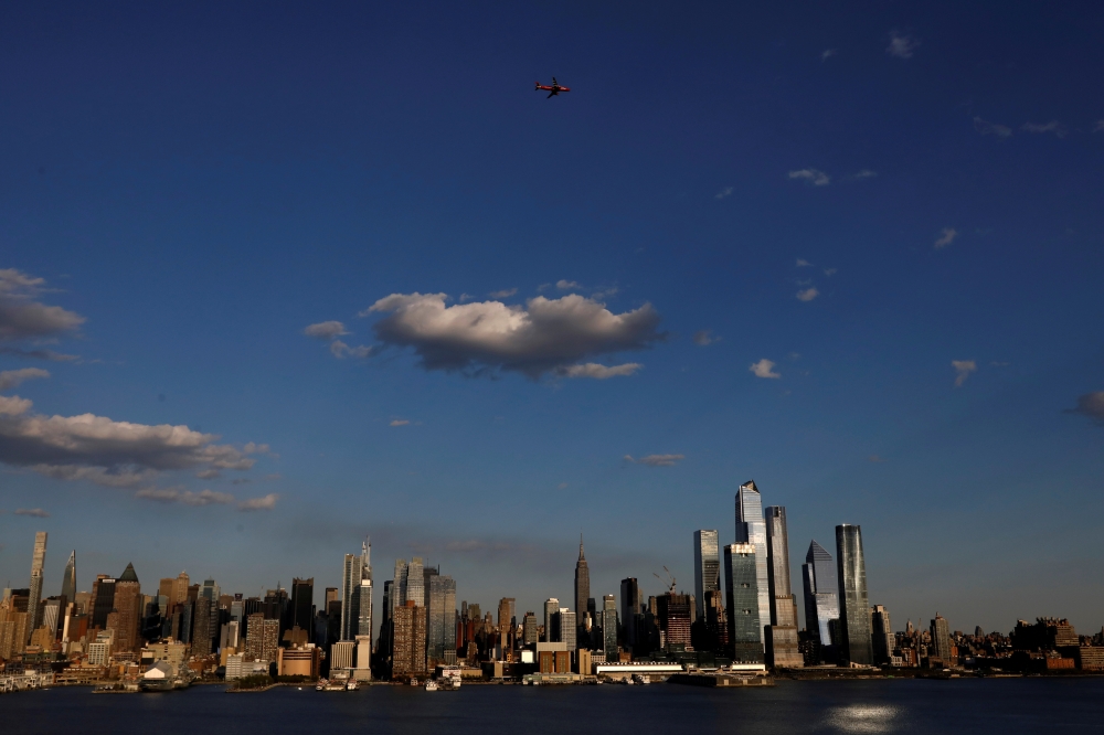 A JetBlue A320 aircraft conducts a flyover salute of New York City to honor frontline healthcare workers during the outbreak of the coronavirus disease (COVID-19), as seen from Weehawken, New Jersey, U.S., May 7, 2020. REUTERS/Brendan McDermid TPX IMAGES 