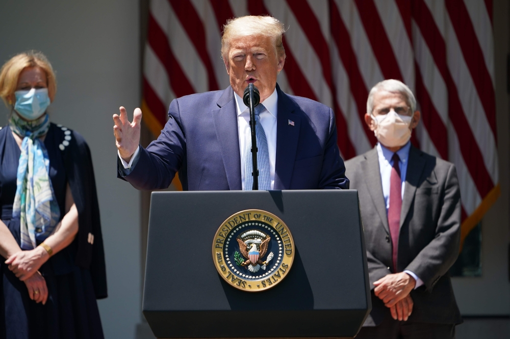In this file photo taken on May 15, 2020 US President Donald Trump, with Response coordinator for White House Coronavirus Task Force Deborah Birx (L) and Director of the National Institute of Allergy and Infectious Diseases Anthony Fauci (R), speaks on va