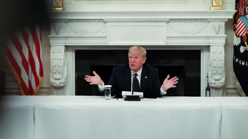 :U.S. President Donald Trump talks about taking daily doses of hydroxychloroquine pills as he addresses a coronavirus disease (COVID-19) pandemic meeting with restaurant executives and industry leaders in the State Dining Room at the White House in Washin