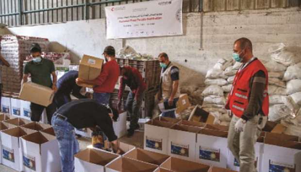 Qatar Red Crescent Society (QRCS), with the funding from Qatar Airways, distributing food baskets to needy families in Gaza and Jordan.
