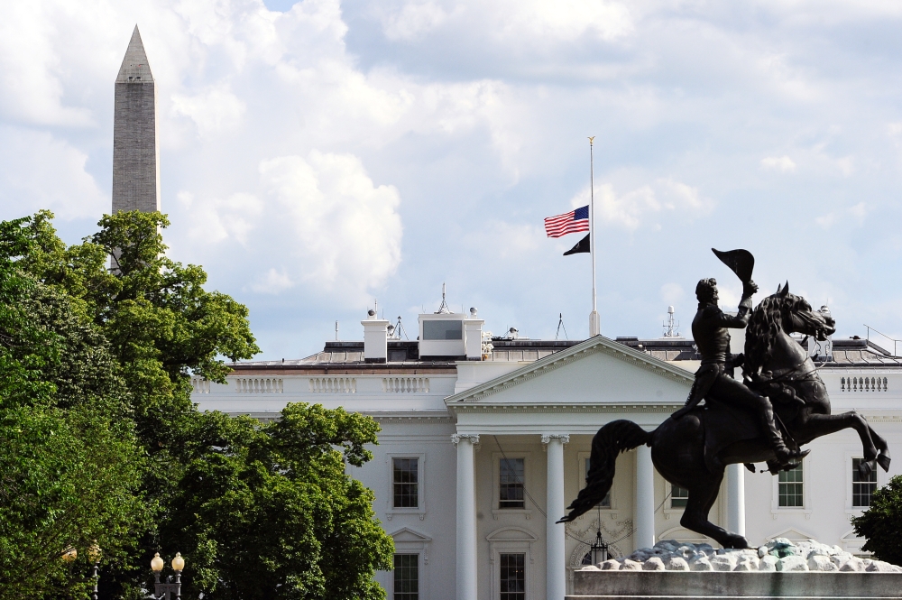 Flags fly at half-staff on the White House to commemorate the victims of the coronavirus disease (COVID-19) in Washington, U.S., May 23, 2020. REUTERS/Mary F. Calvert