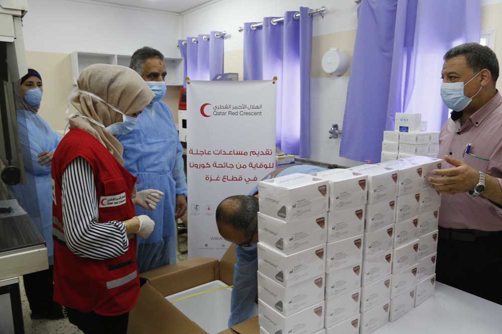 Officials in Gaza with the Qatar Red Crescent Society (QRCS) medical aid.