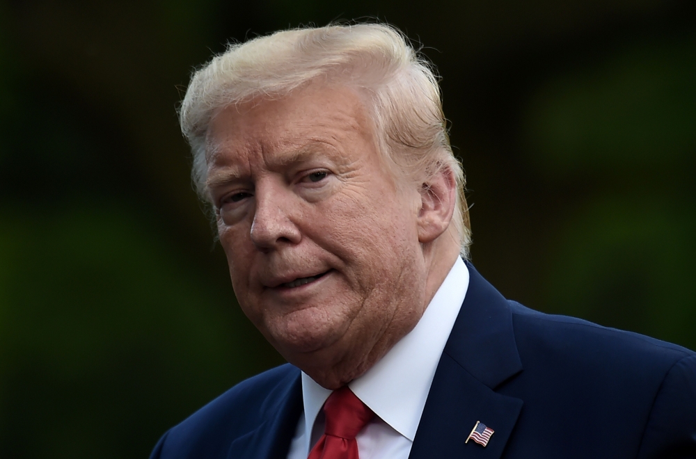 US President Donald Trump walks across the South Lawn upon his return to the White House in Washington, DC on May 27, 2020.  AFP / Olivier DOULIERY