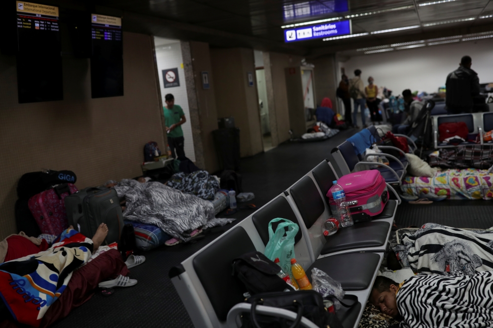 People, part of a group of about 200 Colombians living temporarily at Guarulhos International Airport due to the coronavirus disease (COVID-19) restrictions, sleep at a lobby of the airport, near Sao Paulo, Brazil May 25, 2020. Picture taken May 25, 2020.
