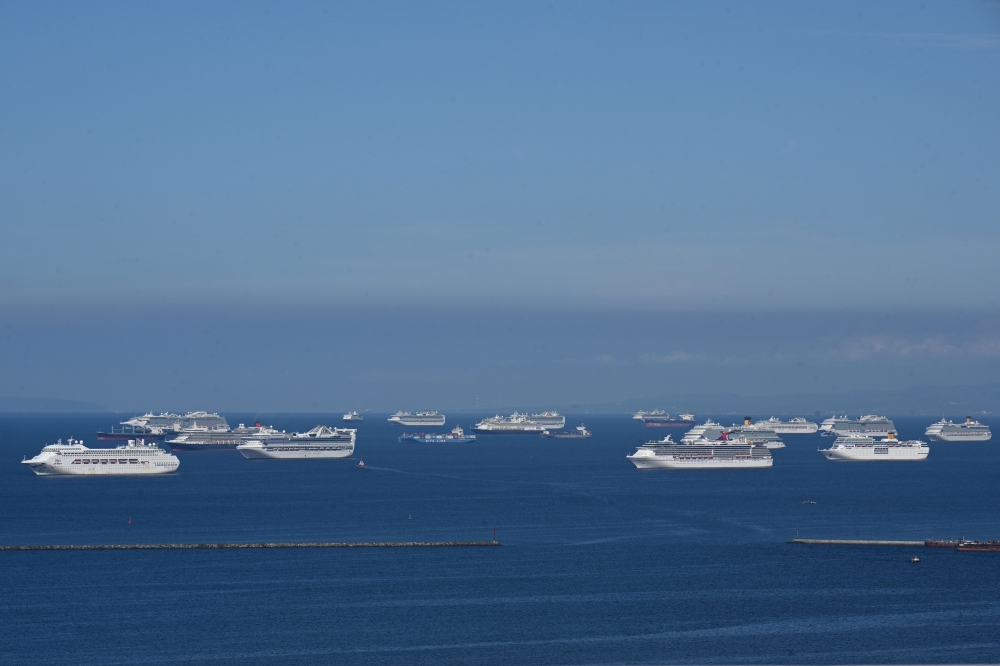 A general view shows cruise ships anchored at Manila Bay on May 31, 2020. More than 20 cruise ships are anchored at Manila Bay waiting for disembarkation clearance from authorities for their Filipino crews who have undergone swab tests for the COVID-19 co