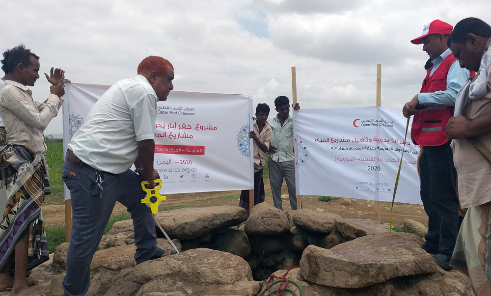 Qatar Red Crescent Society (QRCS) officials at the site of a water well in Yemen.