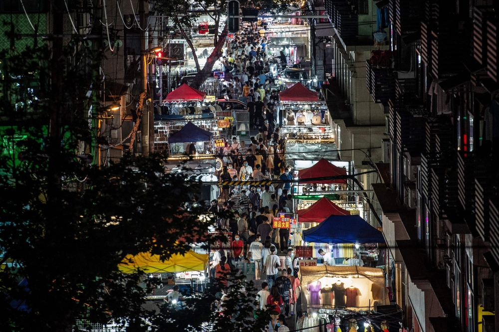 This photo taken on June 3, 2020 shows people visiting a night market in Wuhan in China's central Hubei province. China OUT / AFP / STR