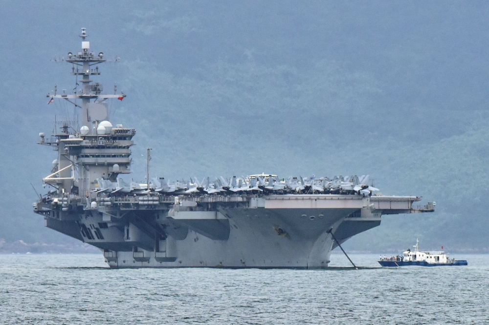 FILE PHOTO: The USS Theodore Roosevelt (CVN-71) is pictured as it enters the port in Da Nang, Vietnam, March 5, 2020. REUTERS/Kham/File Photo
