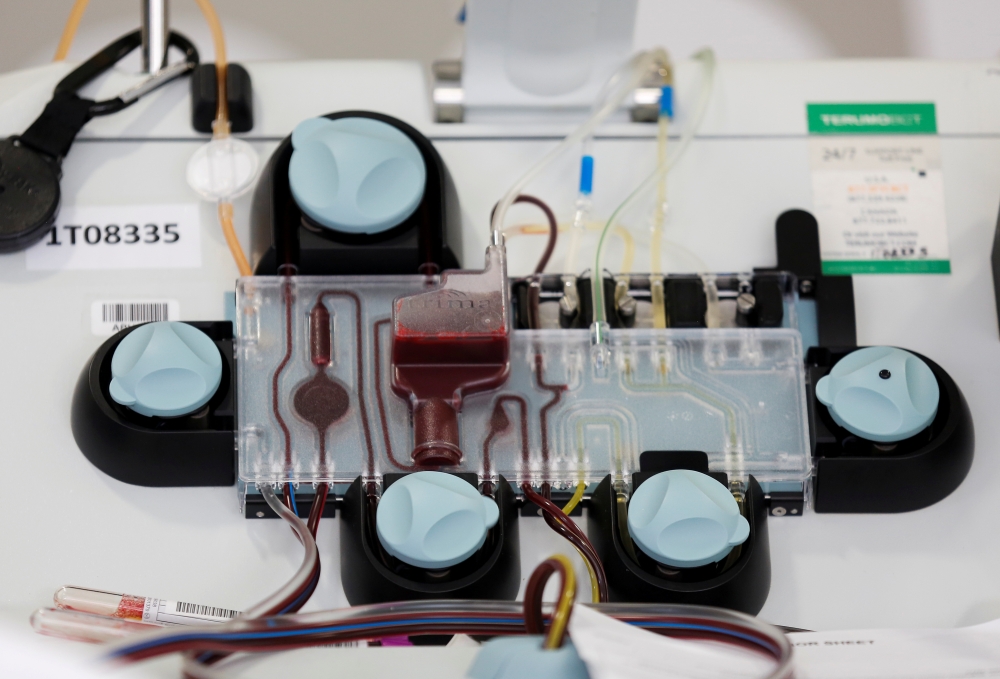 An apheresis machine separates and collects convalescent plasma from the whole blood of a recovered coronavirus (COVID-19) patient at the Central Seattle Donor Center of Bloodworks Northwest during the outbreak in Seattle, Washington, U.S. April 17, 2020.