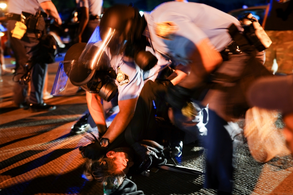 Police detain protesters for blocking traffic during a rally against racial inequality and the police shooting death of Rayshard Brooks, in Atlanta, Georgia, U.S. June 13, 2020. REUTERS/Elijah Nouvelage
