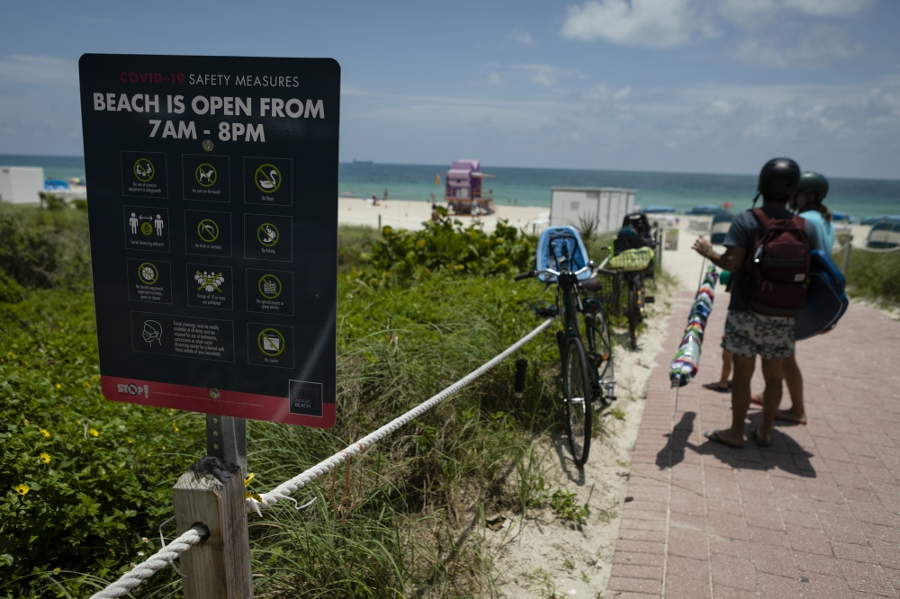 FLORIDA, USA - JUNE 10: A sign with COVID-19 safety measures is seen on the beach as Miami reopens beaches after measures against the novel coronavirus (COVID-19) began to be lifted in Miami Beach, Florida, United States on June 10, 2020. ( Eva Marie Uzca