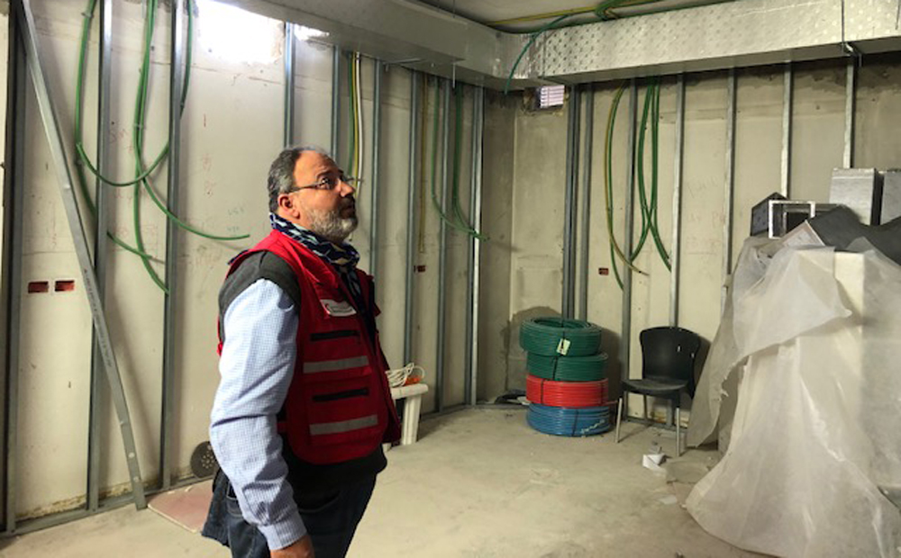 QRCS official at the operations department of the Palestine Red Crescent Society hospital, Al-Quds Branch. RIGHT: Electric panels installed as part of the hospital's renovation project. 