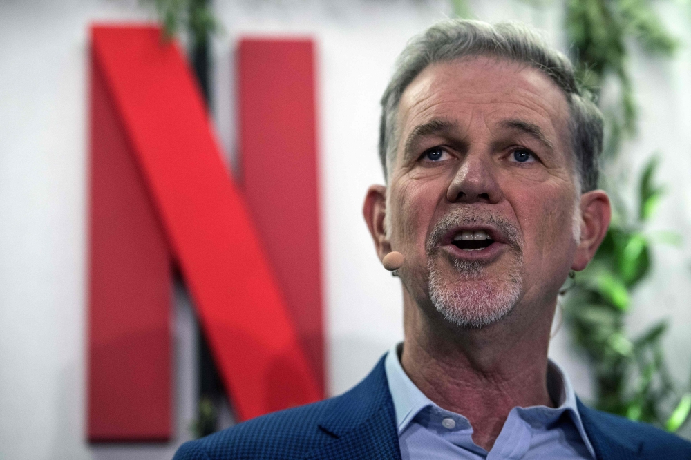 In this file photo taken on January 17, 2020 Co-founder and director of Netflix Reed Hastings delivers a speech as he inaugurates the new offices of Netflix France, in Paris. AFP / Christophe ARCHAMBAULT