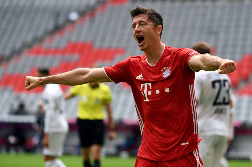 Bayern Munich's Polish forward Robert Lewandowski celebrates after scoring his team's second goal during the German first division Bundesliga football match FC Bayern Munich v SC Freiburg on June 20, 2020 in Munich, southern Germany AFP 