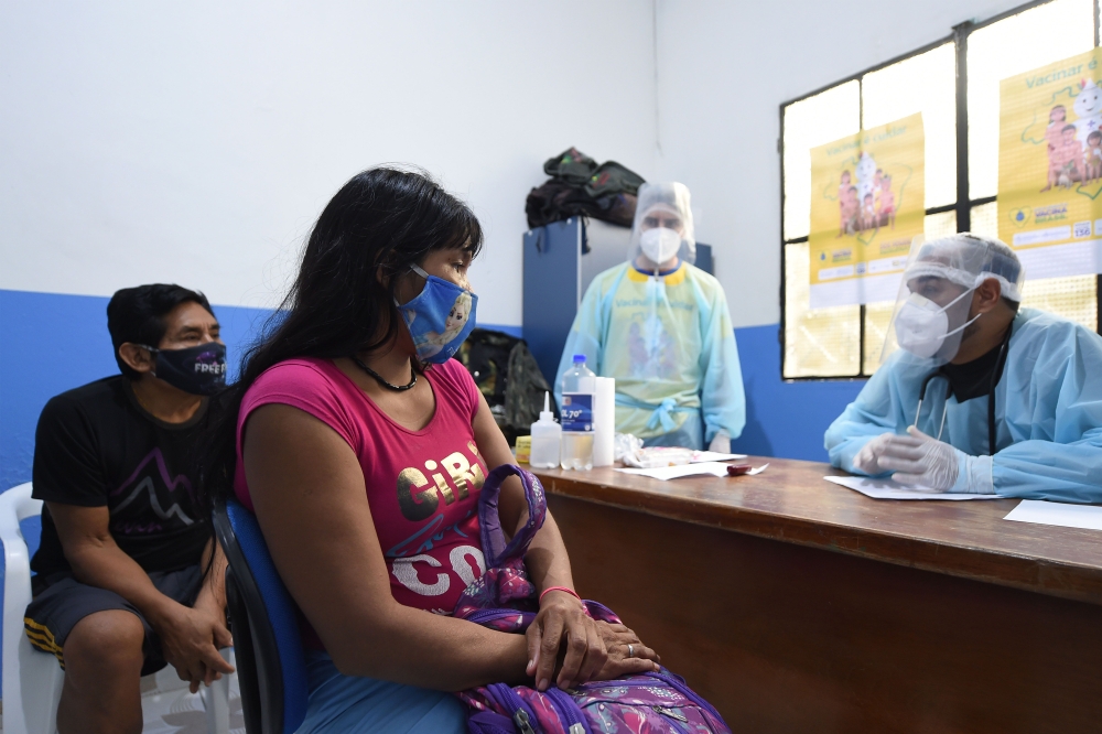 Brazilian indigenous Anita (C) and Nilton of the Marubo ethnic group are notified that they contracted the novel coronavirus by a member of the medical team of the Brazilian Armed Forces at a health post in Atalaia do Norte, Amazonas state, northern Brazi
