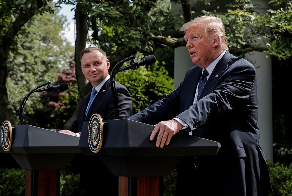 Poland's President Andrzej Duda listens to U.S. President Donald Trump during a joint news conference in the Rose Garden at the White House in Washington, U.S., June 24, 2020. REUTERS/Carlos Barria