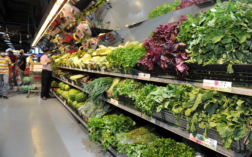 Fresh leaves from local farms and the fruits and vegetables section (right) at the New Indian Supermarket in Doha, yesterday. Pics: Salim Matramkot/The Peninsula