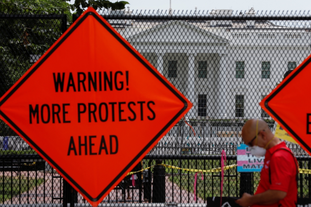 Sings are seen on the fence surrounding the White House as racial inequality protests continue in Washington, U.S., June 27, 2020. REUTERS/Yuri Gripas