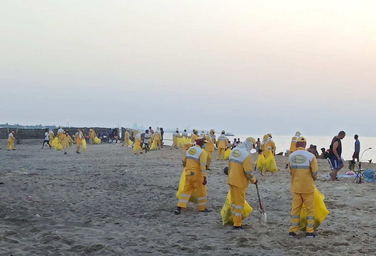 Teams from the General Cleanliness Department of the Ministry of Municipality and Environment cleaning the Sealine public beach which has been reopened to the public as part of the gradual lifting of coronavirus restrictions in the country. 