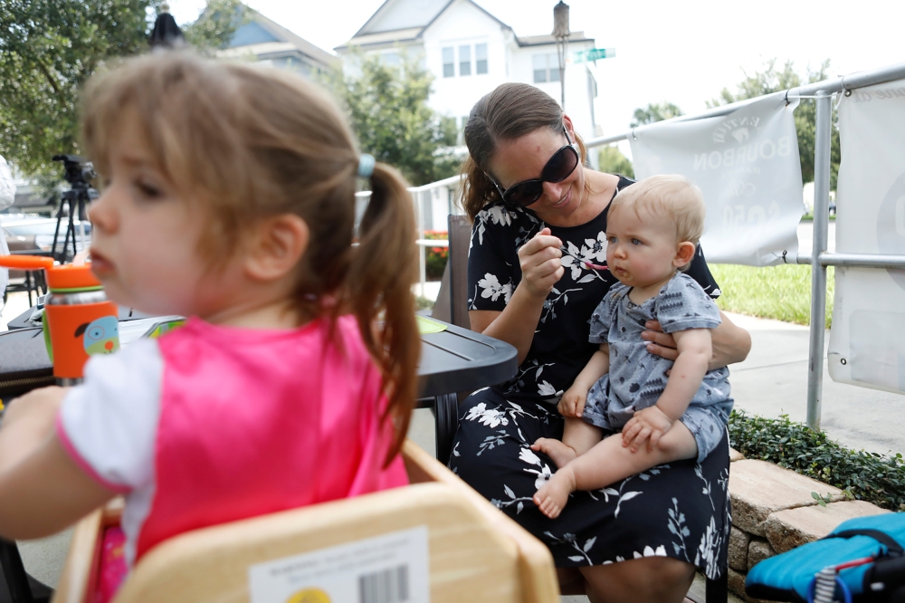Barbara Andreas feeds her 11-month-old son Waylan during the reopen Florida 