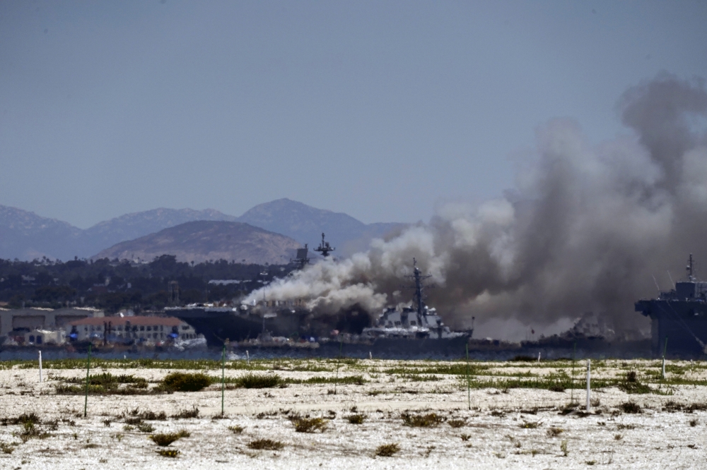 Smoke rises from a fire on board the U.S. Navy amphibious assault ship USS Bonhomme Richard at Naval Base San Diego, as seen from Coronado, California, U.S. July 12, 2020. REUTERS/Bing Guan
