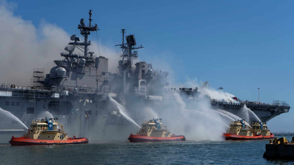 Boats combat a fire on board the U.S. Navy amphibious assault ship USS Bonhomme Richard at Naval Base San Diego, California, U.S. July 12, 2020. Picture taken July 12, 2020. U.S. Navy/Mass Communication Specialist 3rd Class Christina Ross/Handout via REUT