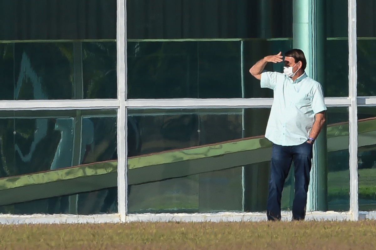 Brazilian President Jair Bolsonaro gestures outside the Alvorada Palace in Brasilia, Brazil, on July 14, 2020, in the midst of the COVID-19 coronavirus pandemic. Bolsonaro tested positive for the coronavirus on July 7, after months minimizing the dangers 