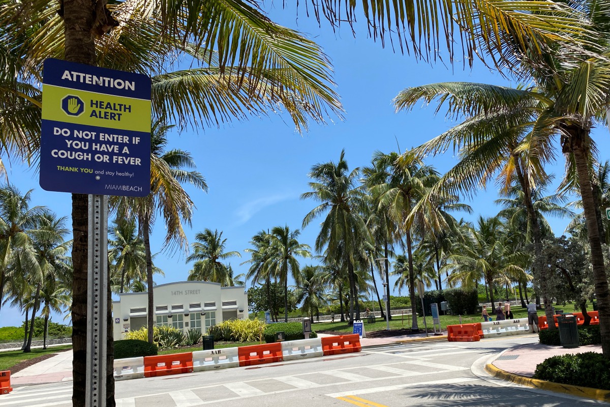 A sign warning about the spread of coronavirus disease (COVID-19) is seen in Miami Beach, Florida, U.S. July 14, 2020. Picture taken July 14, 2020. REUTERS/Zachary Fagenson
