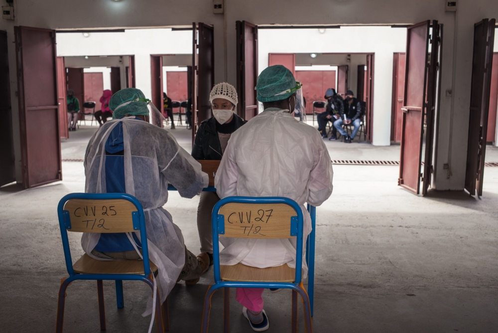 A doctor consults a patient before screening for COVID-19 coronavirus at the COVID-19 Medical Centre of Andohatapenaka in Antananarivo on July 20, 2020. / AFP / RIJASOLO