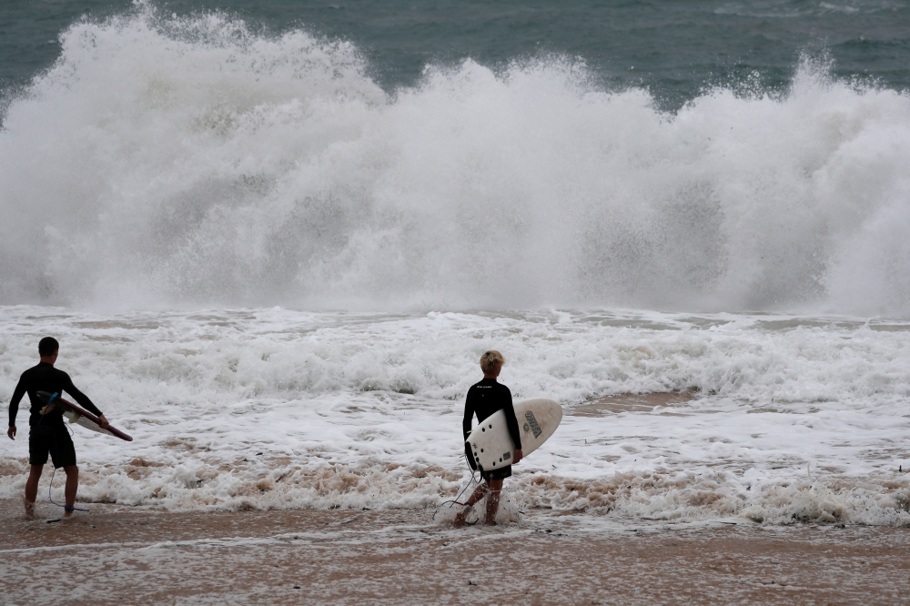 Surfers take to the waves at Pounder's Beach in Laie, Hawaii, U.S. July 26, 2020, as Hurricane Douglas makes its way towards Oahu. REUTERS/Marco Garcia