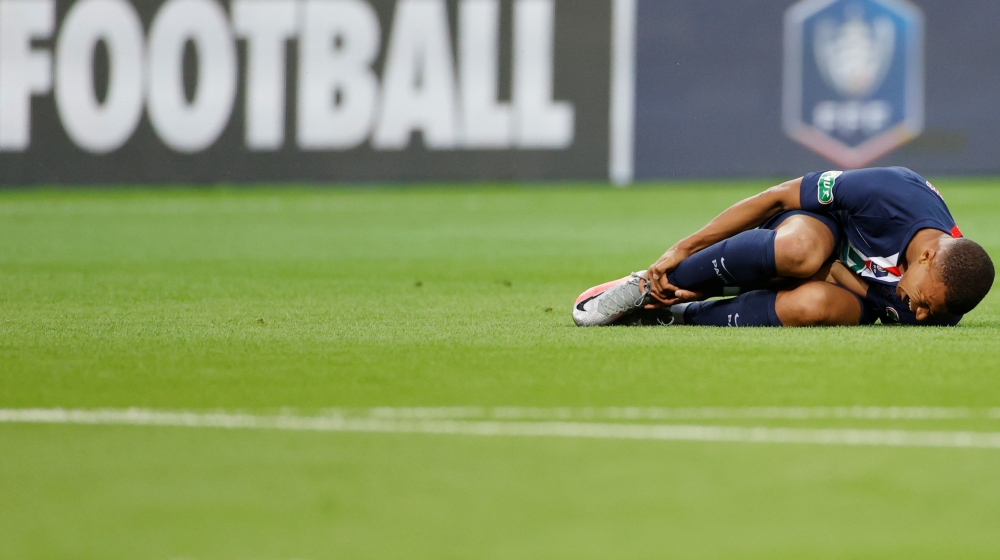 Soccer Football - Coupe de France - Final - Paris St Germain v AS Saint-Etienne - Stade de France, Saint-Denis near Paris, France - July 24, 2020 Paris St Germain's Kylian Mbappe reacts after sustaining an injury, following the outbreak of the coronavirus