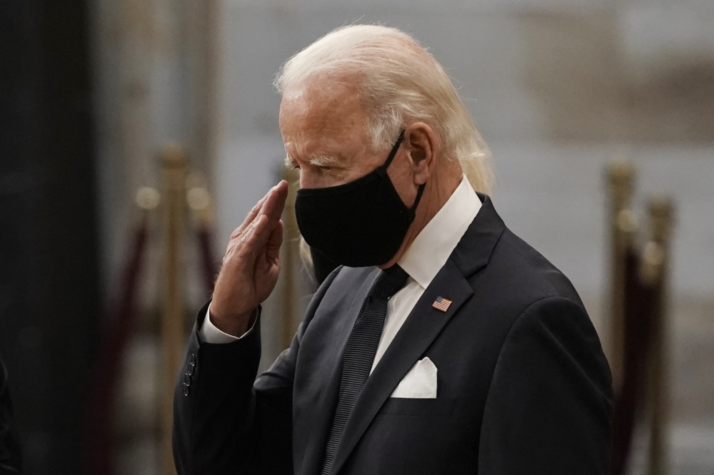 Democratic presidential candidate, former Vice President Joe Biden salutes at the flag-draped casket of the late Rep. John Lewis, D-Ga., a key figure in the civil rights movement and a 17-term congressman from Georgia, as he lies in state at the Capitol i