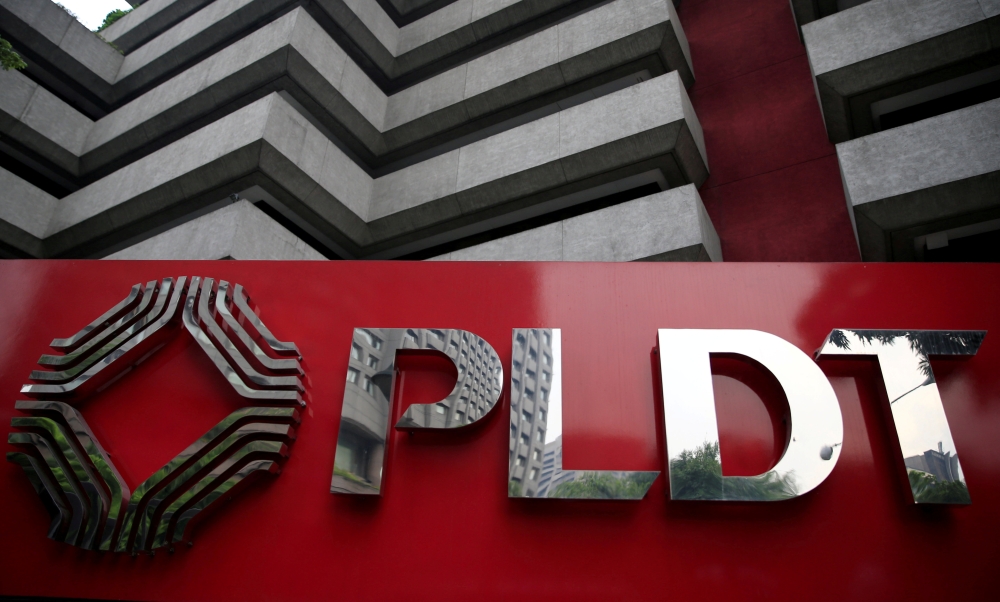FILE PHOTO: FILE PHOTO: A logo of Philippine Long Distance Telephone Company (PLDT) is seen in front of their building in Makati city, metro Manila, Philippines May 30, 2016. REUTERS/Romeo Ranoco/File Photo