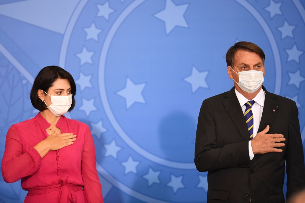 Brazilian President Jair Bolsonaro and the first lady Michelle Bolsonaro attend the launch of the Rural Women's Rights program at Planalto Palace in Brasilia, on July 29, 2020. This is the first public appearance of Bolsonaro in an official event after he
