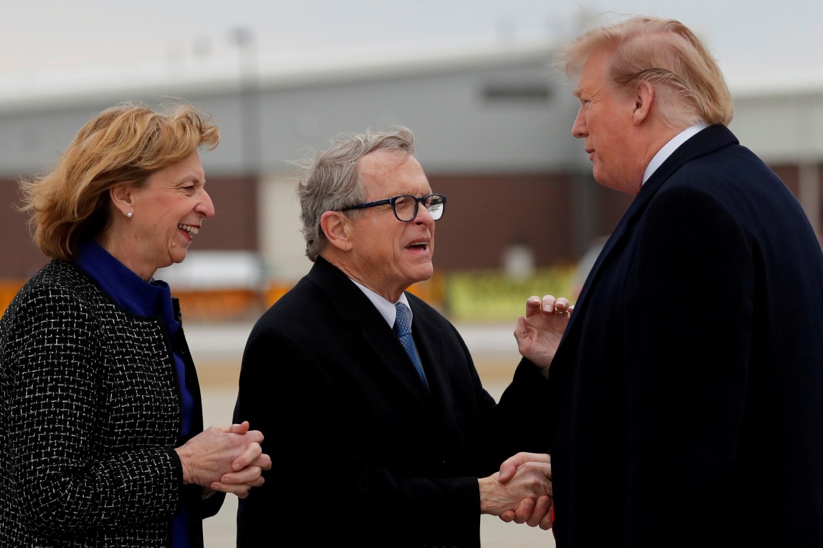 FILE PHOTO: U.S. President Donald Trump shakes hands with Governor of Ohio Mike DeWine as he arrives at Akron-Canton airport in Canton, Ohio, U.S., March 20, 2019. REUTERS/Carlos Barria/File Photo
