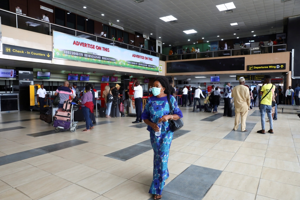 FILE PHOTO: A woman wears a protective face mask due to the spread of the coronavirus disease (COVID-19), at the Murtala Mohammed International airport in Lagos, Nigeria March 19, 2020. Picture taken March 19, 2020. REUTERS/Temilade Adelaja/File Photo