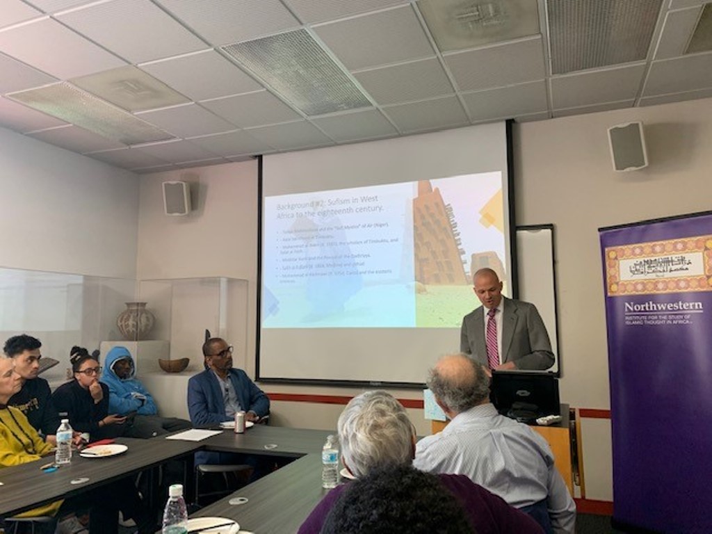 Zachary Wright presenting his research at the speaker series event
