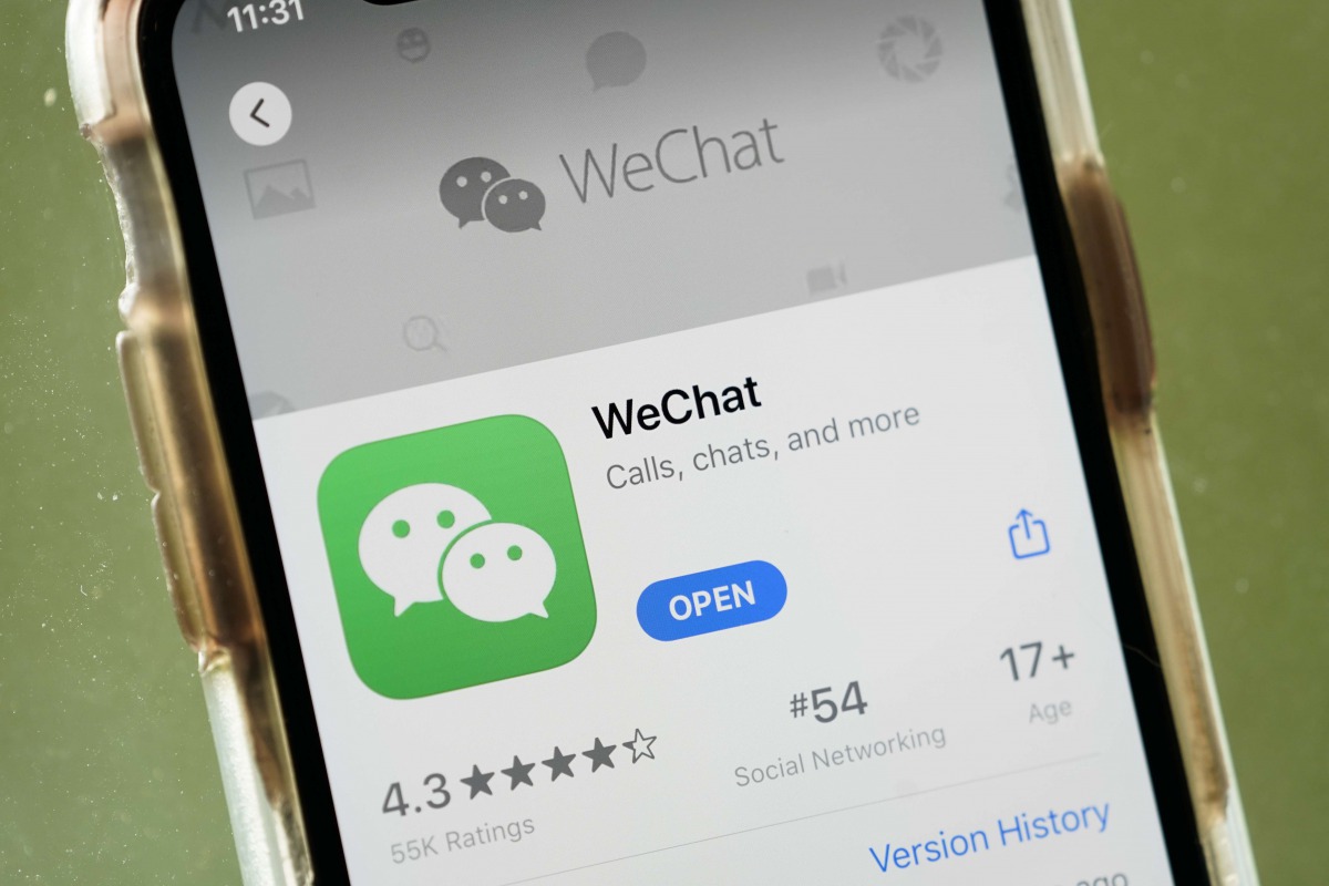 WASHINGTON, DC - AUGUST 07: In this photo illustration, the WeChat app is displayed in the App Store on an Apple iPhone on August 7, 2020 in Washington, DC. On Thursday evening, President Donald Trump signed an executive order that bans any transactions b