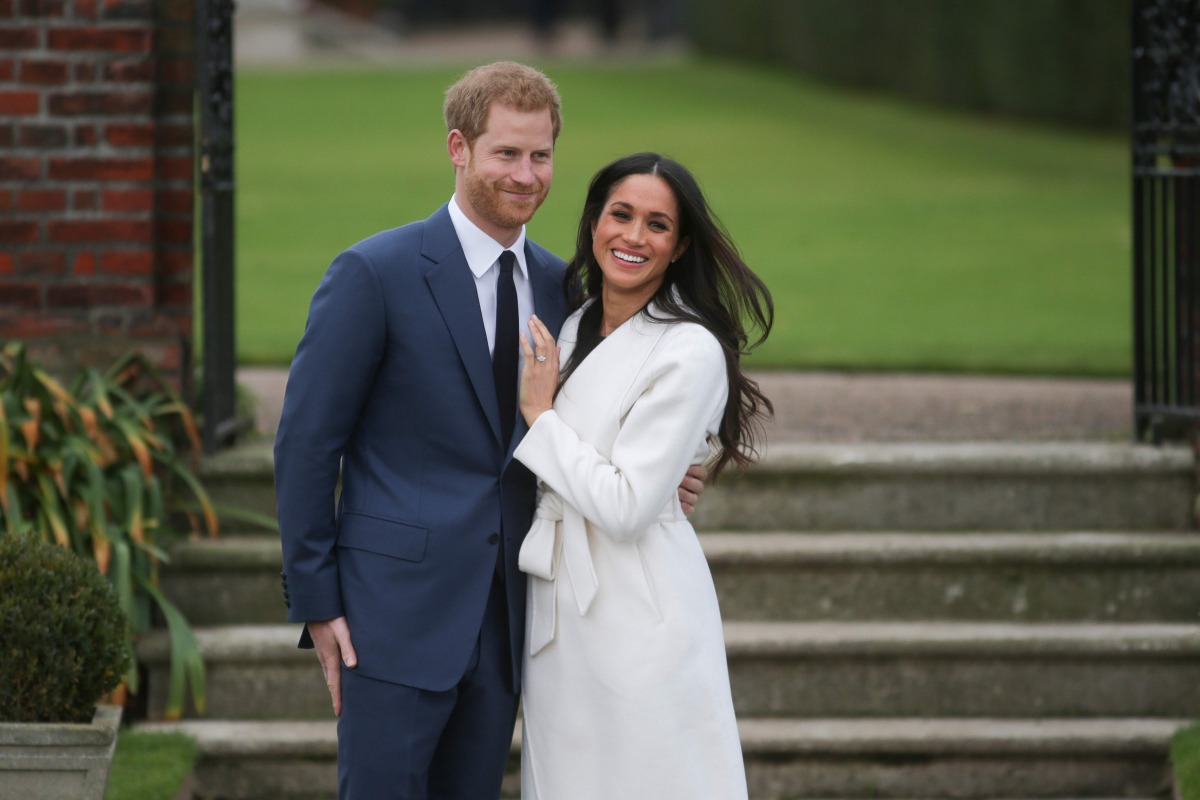 (FILES) In this file photo taken on November 27, 2017 Britain's Prince Harry and his fiancée US actress Meghan Markle pose for a photograph in the Sunken Garden at Kensington Palace in west London, following the announcement of their engagement./ AFP / Da